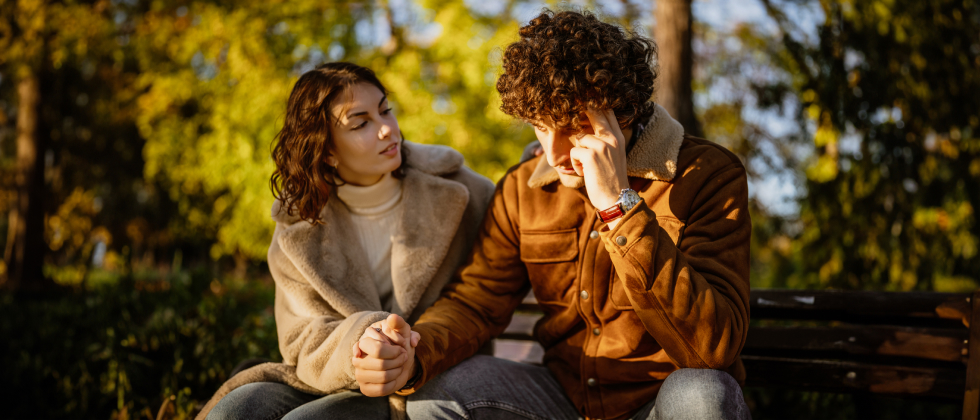 a couple sitting, holding hands