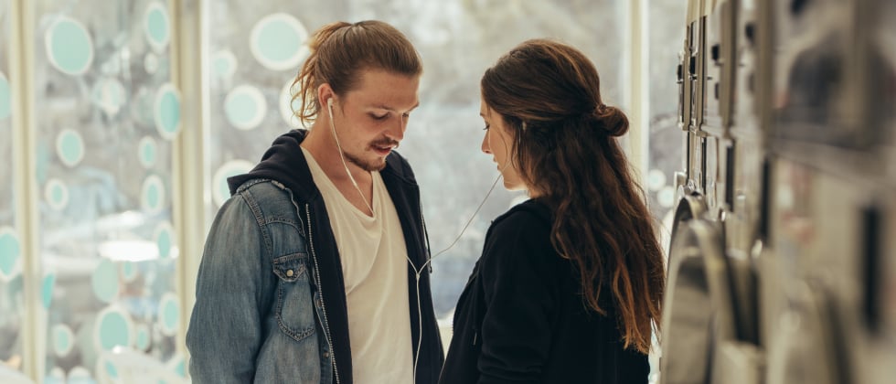 Man and woman standing in front of each other, but both looking down at the ground as a symbol of introvert dating