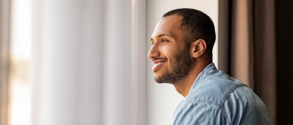 A guy looking into the distance and smiling