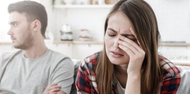 Couple having an argument with each other on the couch