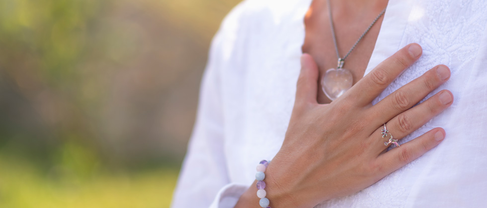 Calming image of a woman holding her hand over her heart